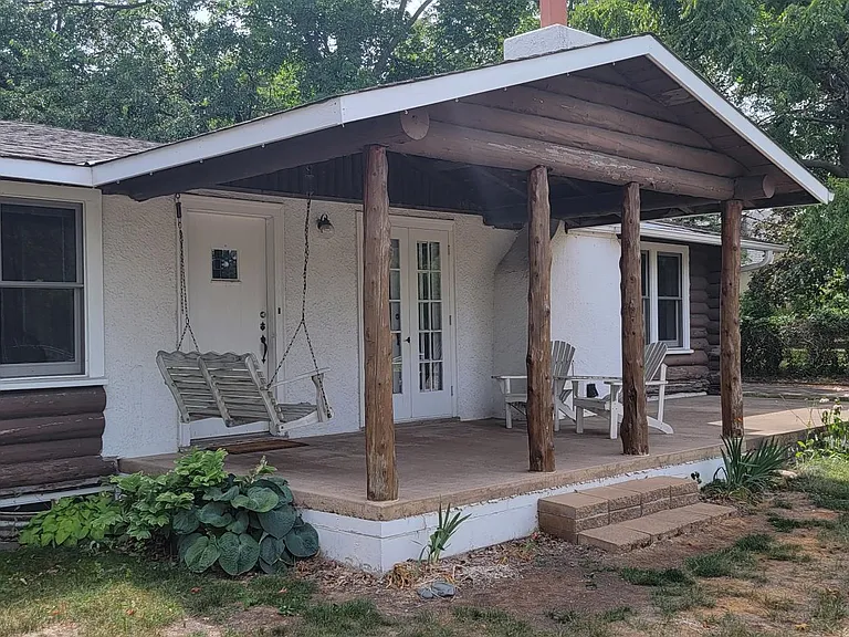 Beautiful front porch with 2 or 3 person bench swing, table and chairs, and of course, the beautiful original glass hindged patio doors directly to the livingroom