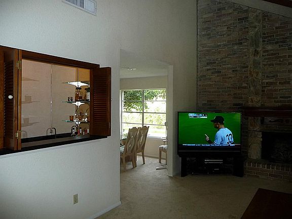 Another view left side of Family Room, opening to wet bar that can be closed off
