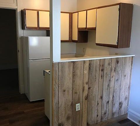 Looking back from living room to kitchen and entry door