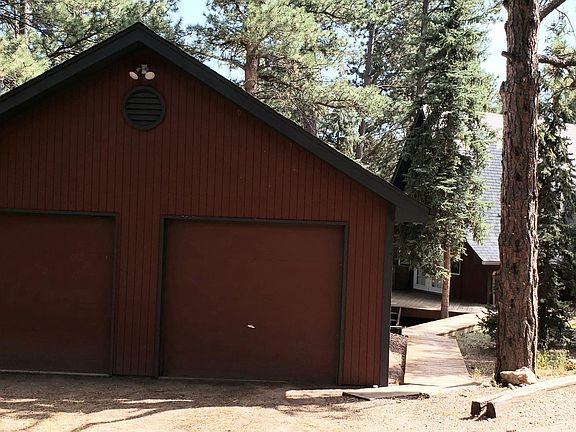 Large oversize 2 car garage with work bench and shelves. Manual garage doors. Horse shoe driveway. Very easy access and road well maintained.