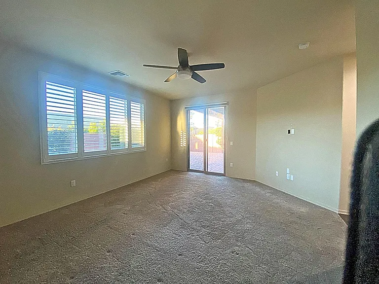 Primary bedroom with TV Mount and Sliding doors to the covered paver patio.