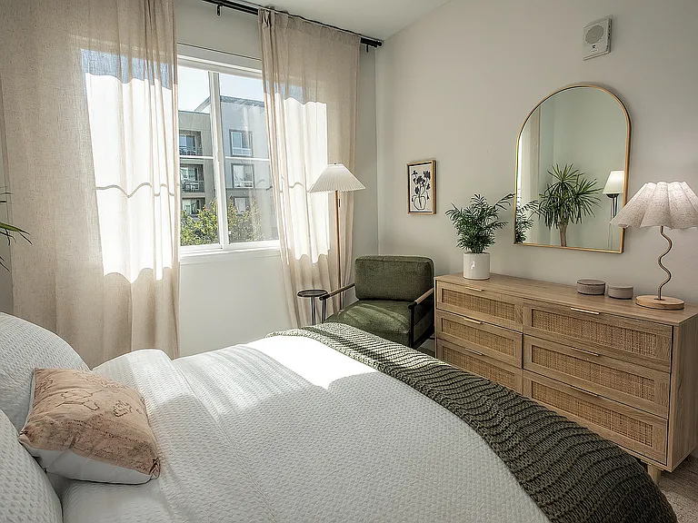 Sun-filled bedroom featuring refined furnishings, stylish accents, and generous closet space.