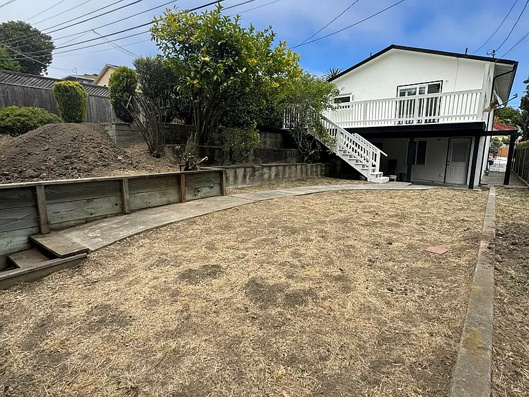 lower yard w/view of house from back