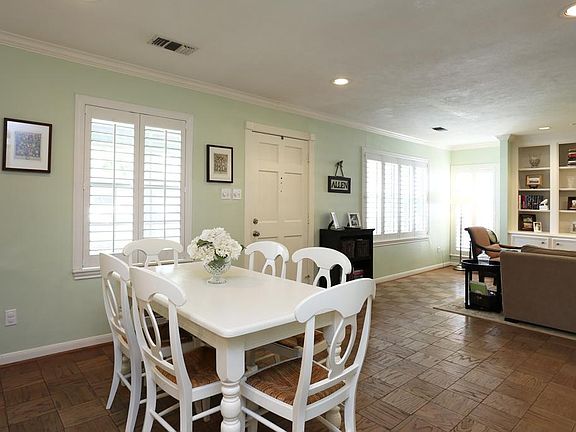 Open dining room and den with plantation shutters. Light and bright!