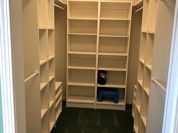 Upstairs primary bedroom's walk-in closet