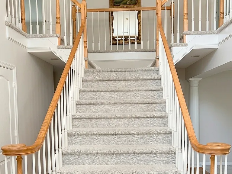 Staires to each side of second floor rooms.
