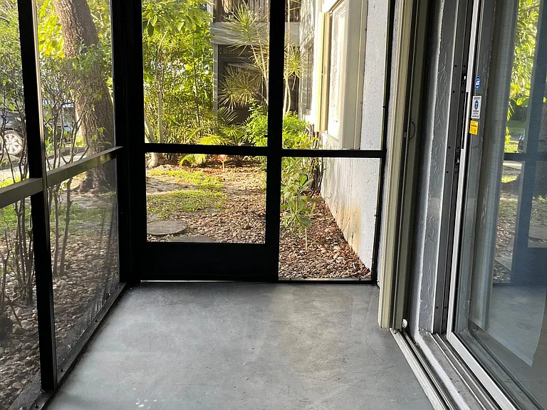 Screen patio area, there are hurricane accordion sliders on the sliding doors and bedroom window.