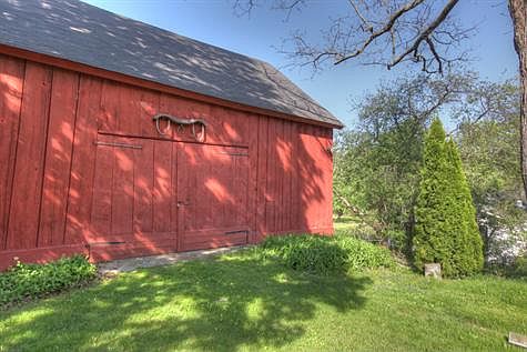 a colonial 3-story timber-framed barn