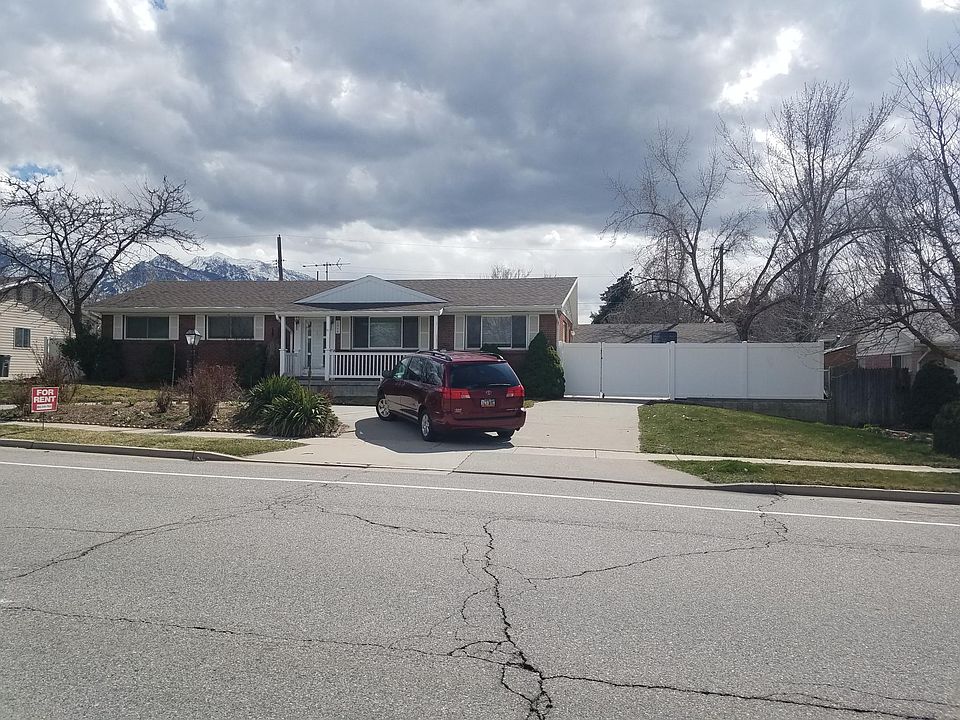 House front showing the porch and fenced gated entry and circular drive way