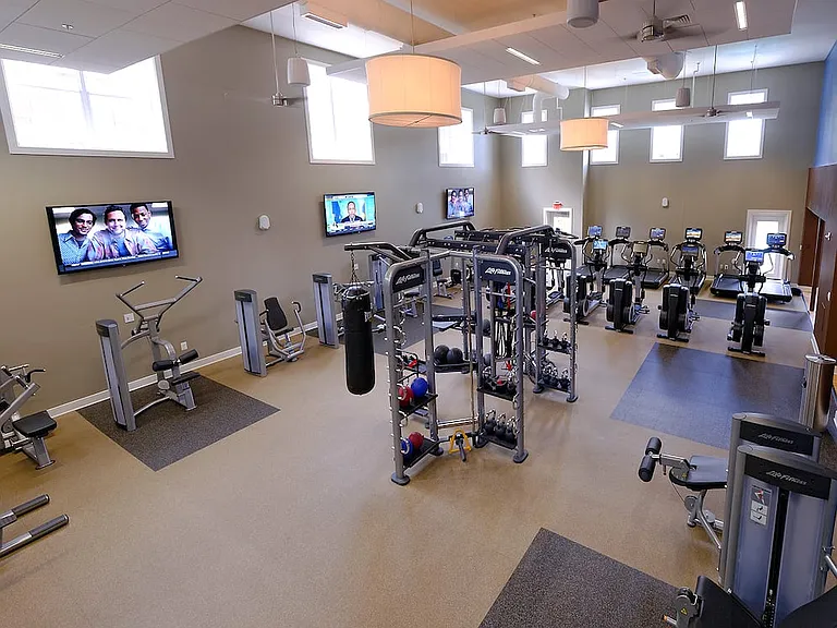 Fitness center with strength training equipment, cardio equipment and flatscreen televisions