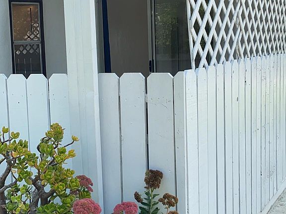 Very private patio enclosure, lattice fencing on both sides.