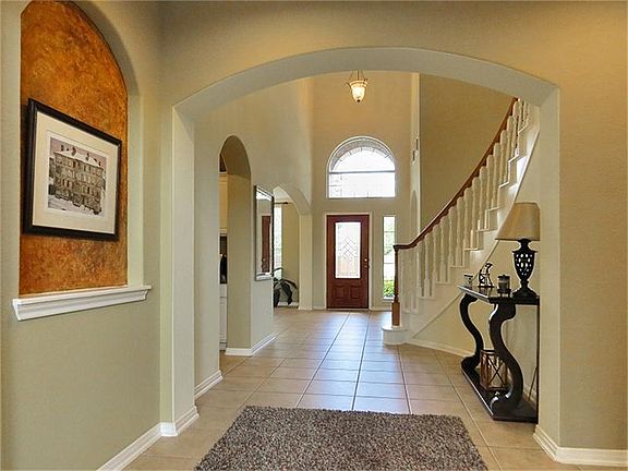 Double story entry and semi-grand staircase.