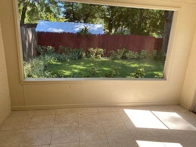 Screen porch looking into back yard and yes you have a complete back yard