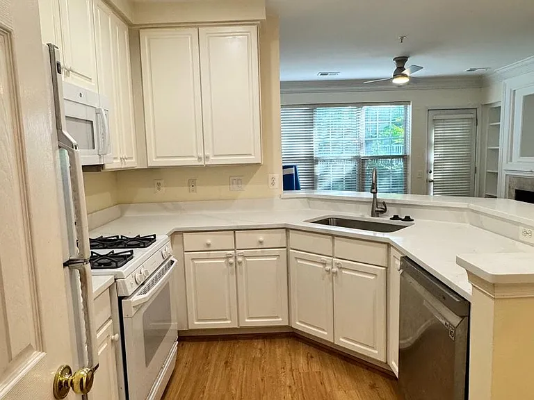 Kitchen with new quatzite countertop, stainless steel sink, wood floor