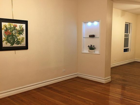 Front room showing ceiling fan with lights and picture molding which allows you to hang picture anywhere along the molding with rods which allows you to change your art easily. (or you can hang pictures the old fashioned way)