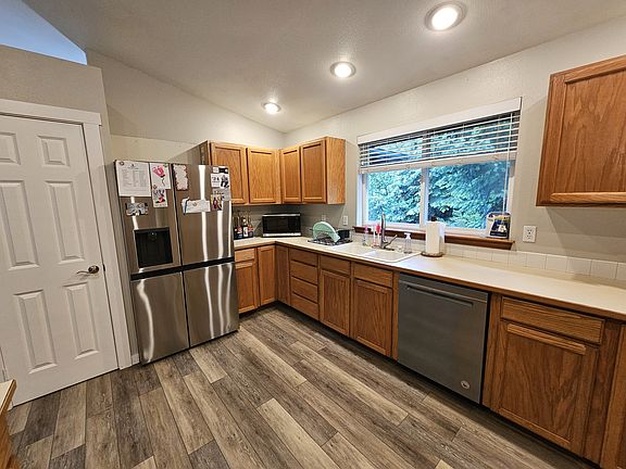 Large kitchen with plenty of cabinet storage, counter space and a pantry. New stainless steal appliances.