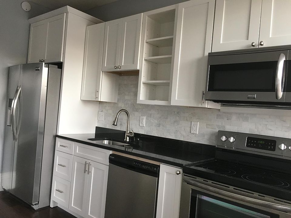 Beautiful kitchen with black granite countertops and marble backsplash.