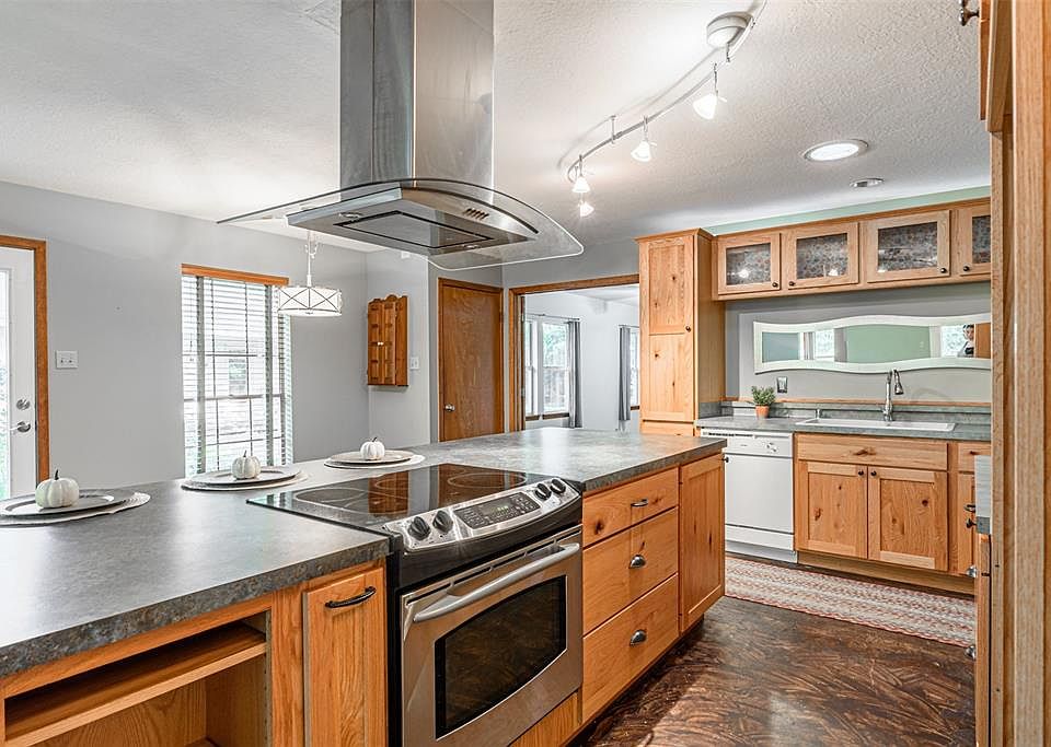 Spacious kitchen with large island, electric cook top, and tons of cabinet storage.