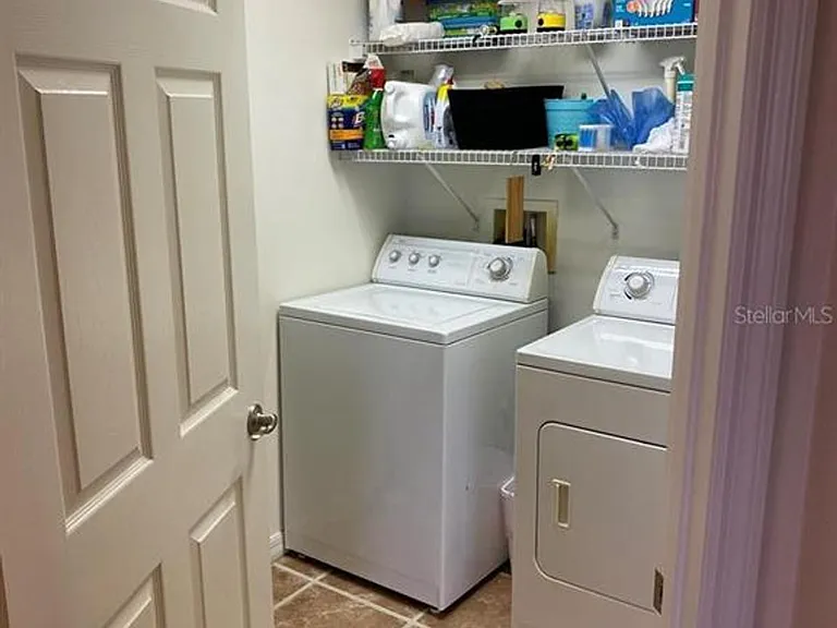 Laundry room with ironing board