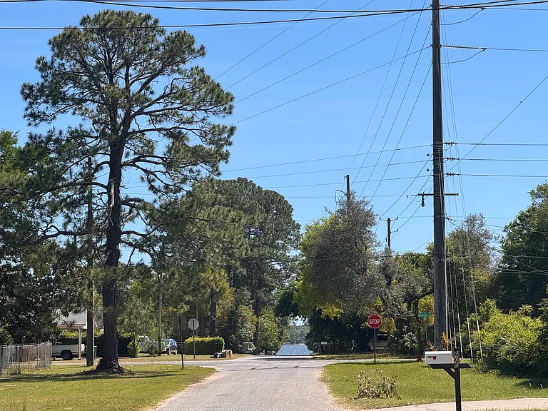Standing in front of the house looking at the waters of Bayou Grande. At the end of the road there is public access to the bayou. Launch your kayak or paddle board. Pull your boat of to the sandy beach.