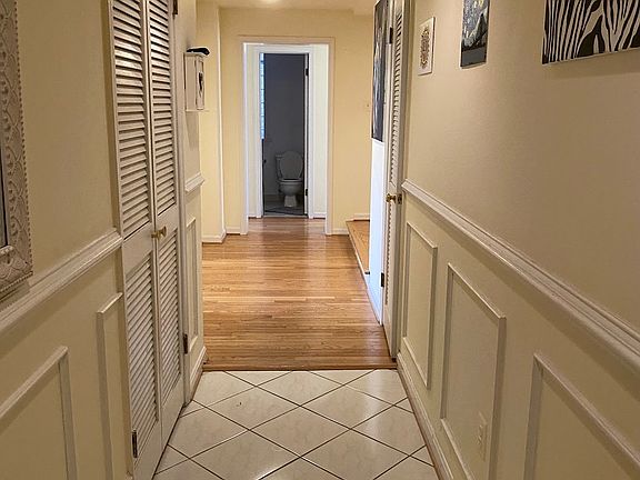 Entrance hallway w/ coat & storage (right) closet and washer/dryer closet (left)