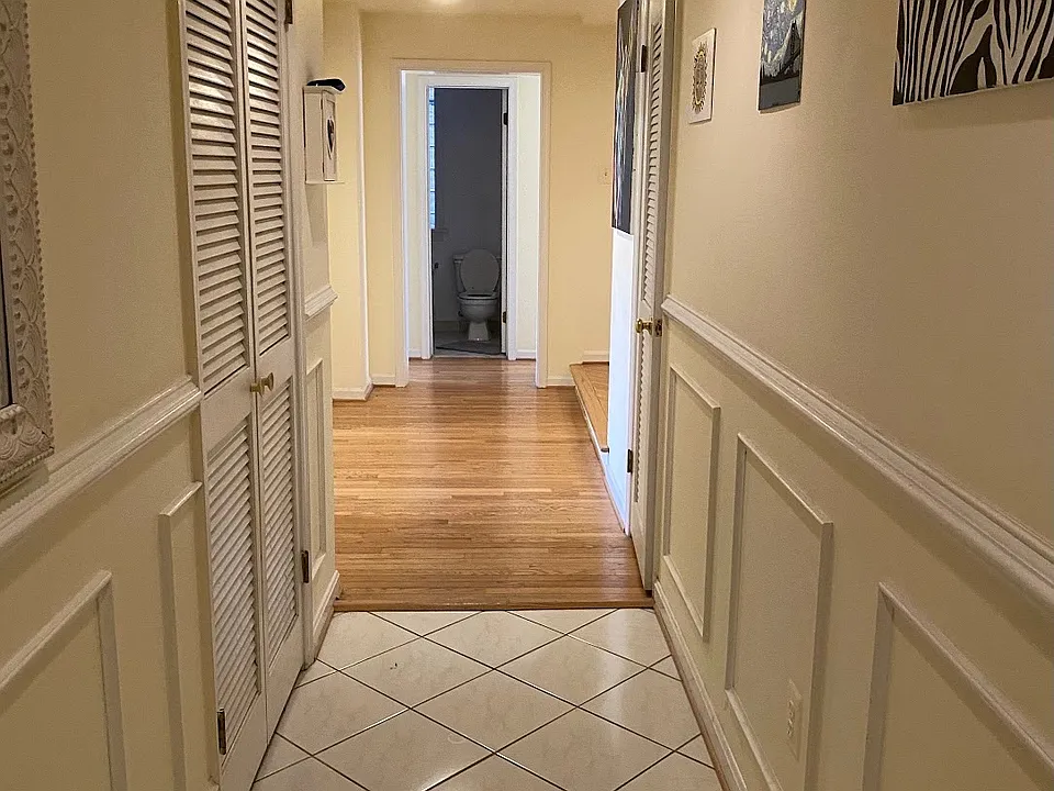 Entrance hallway w/ coat & storage (right) closet and washer/dryer closet (left)