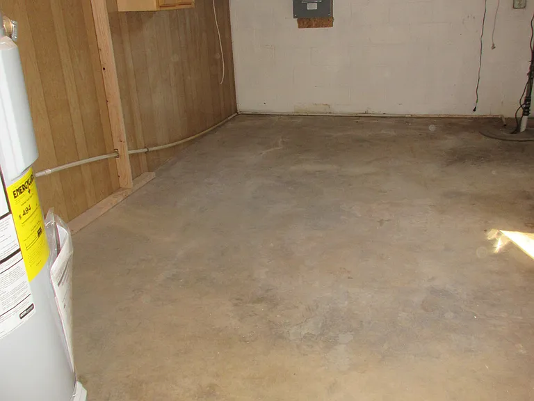 Unfinished area of basement has furnace, water heater and laundry hookups