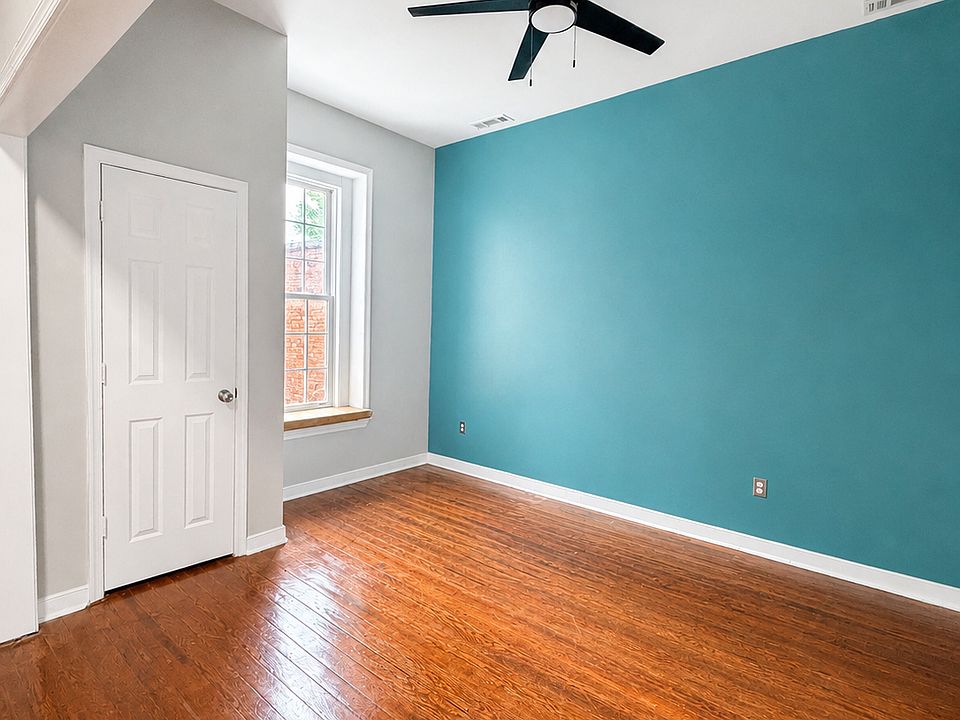 Bright second room with high ceilings, beautiful hardwood floors, a ceiling fan, and great natural light. Great for an office, living room, or second / guest bedroom space.