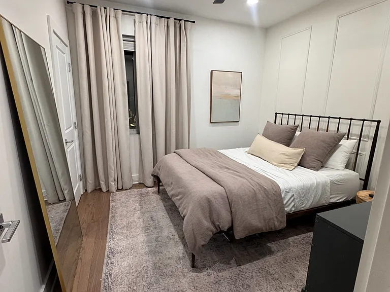 The primary bedroom features a queen-sized Purple-brand mattress. Not pictured is the walk-in closet.