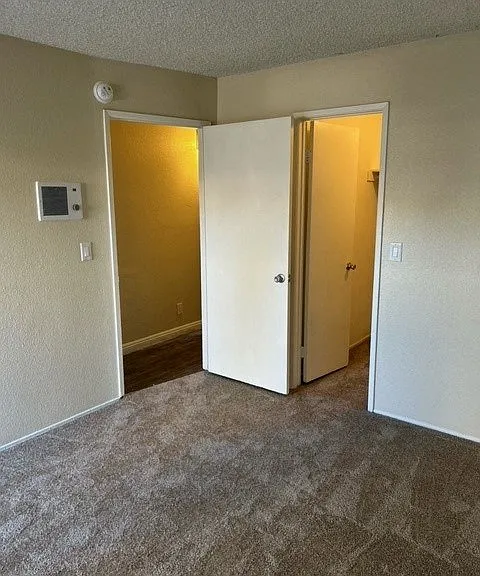 Bedroom with walk-in closet at Mission Bell Apartments.