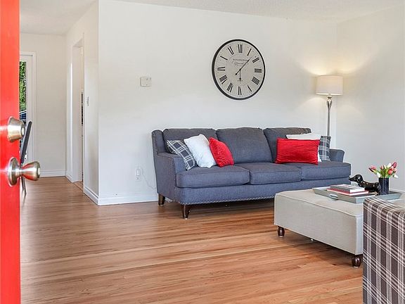 The front door opens to gleaming hardwoods.