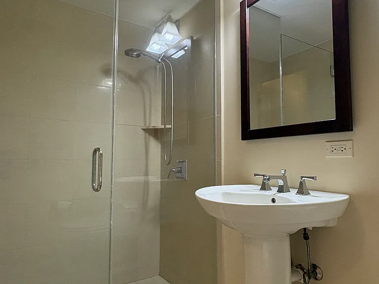 2nd bathroom shower and pedestal sink.
