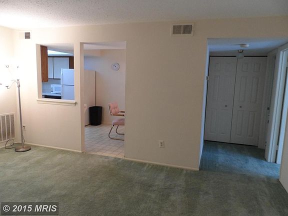 Living room looking into kitchen and hallway