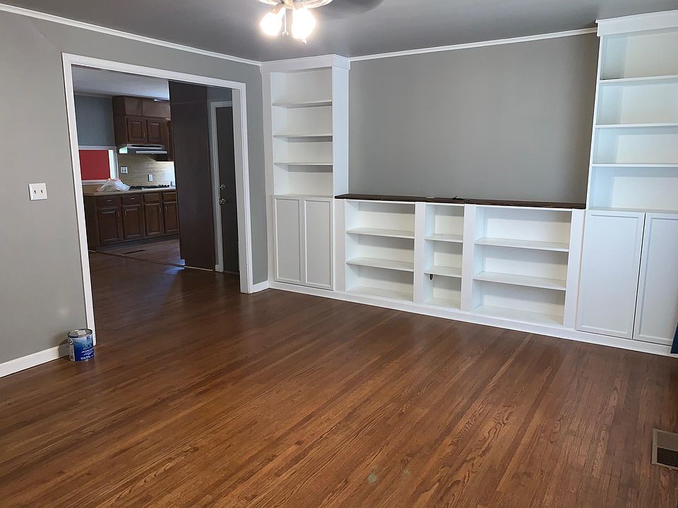 Living room with view into dining/kitchen area.