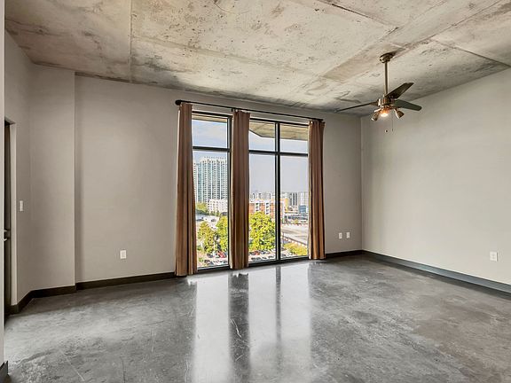 Bedroom with floor to ceiling windows and balcony
