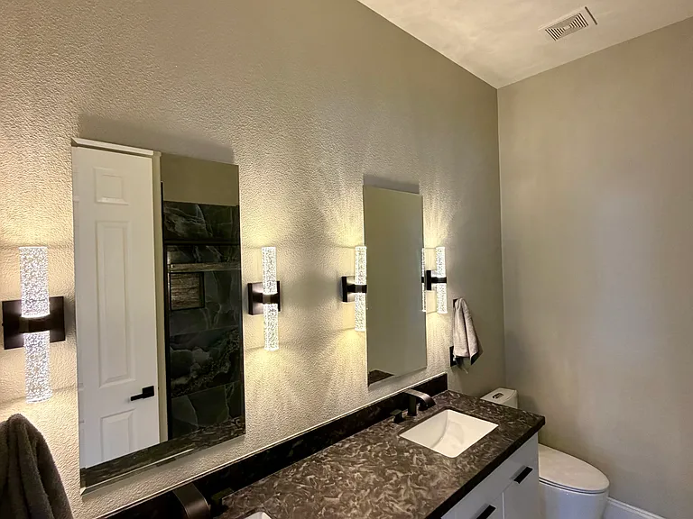 Second-Floor loft full bathroom with European-Style high-gloss white cabinetry and granite countertops