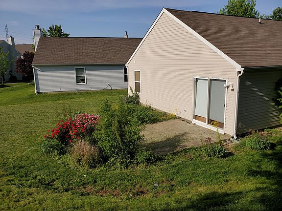 BACK PATIO W/ COLORFUL FLOWERS