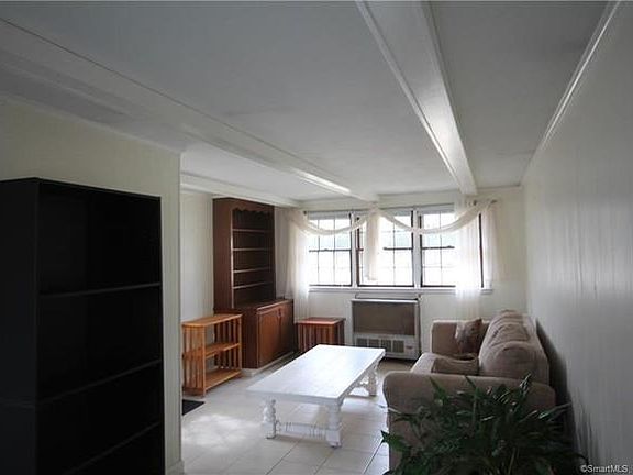 Family room connected to the backyard, front door, garage, and kitchen