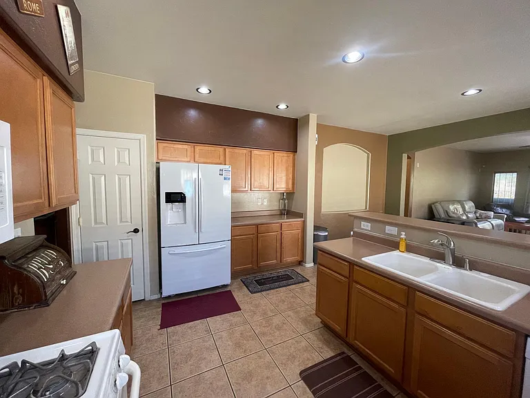 Kitchen with pantry to the left of fridge