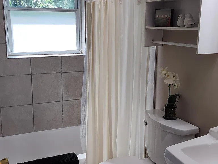 Bath with tile shower/tub combination.
