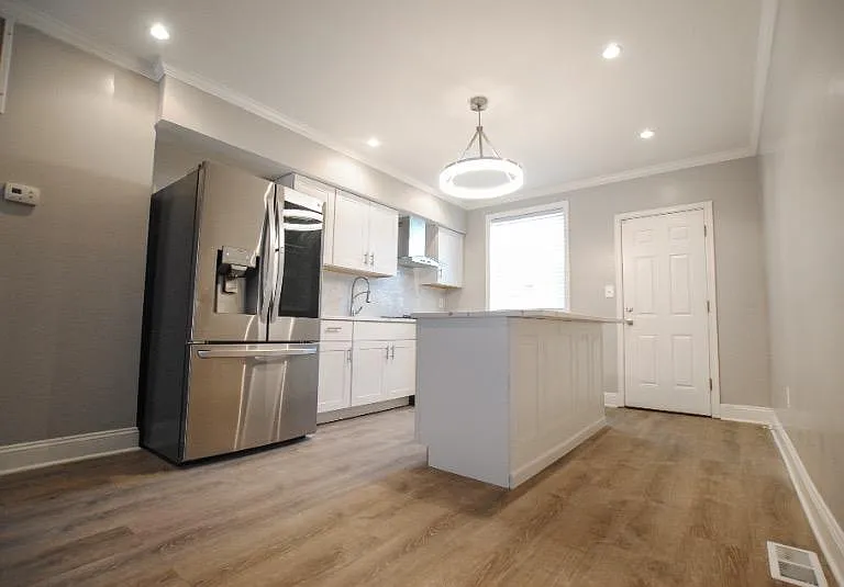 Walk in to an open first level; head to the back of the house to find the upgraded kitchen