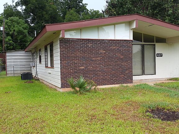 Front of House, Utility Shed in back.