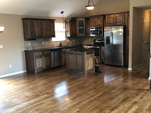 Open concept floor plan with spacious kitchen with island and all appliances included plus side-by-side refrigerator