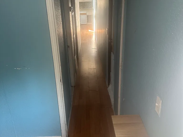 Main bedroom looking down hall to kitchen