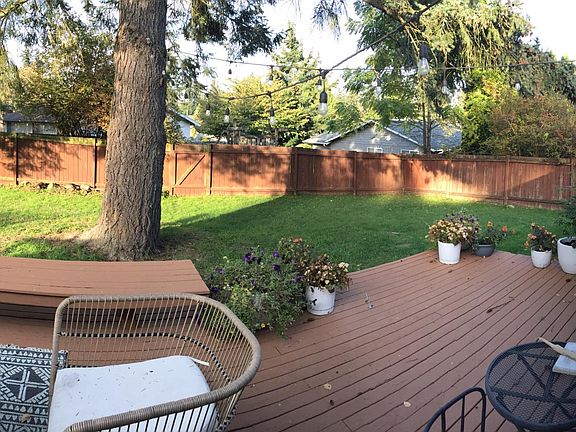 Pano view of the large, flat and fully-fenced backyard with a huge deck, perfect for summer BBQ.