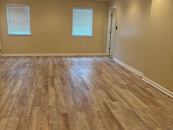Large master bedroom with tile floors, ample space, and private door leading to the screened porch_perfect for enjoying indoor-outdoor living.