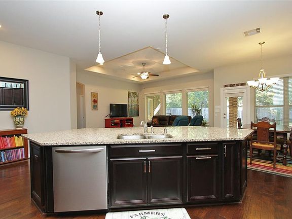 Here's another view looking at the island with the stainless steel under mount sink and dishwasher.