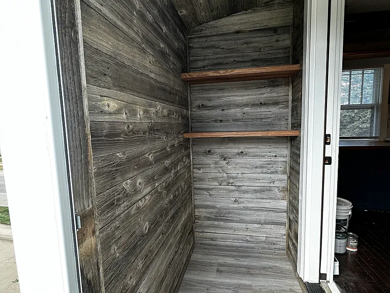 Rear pantry way as you enter, with storage. Custom lined with recycled barn fence