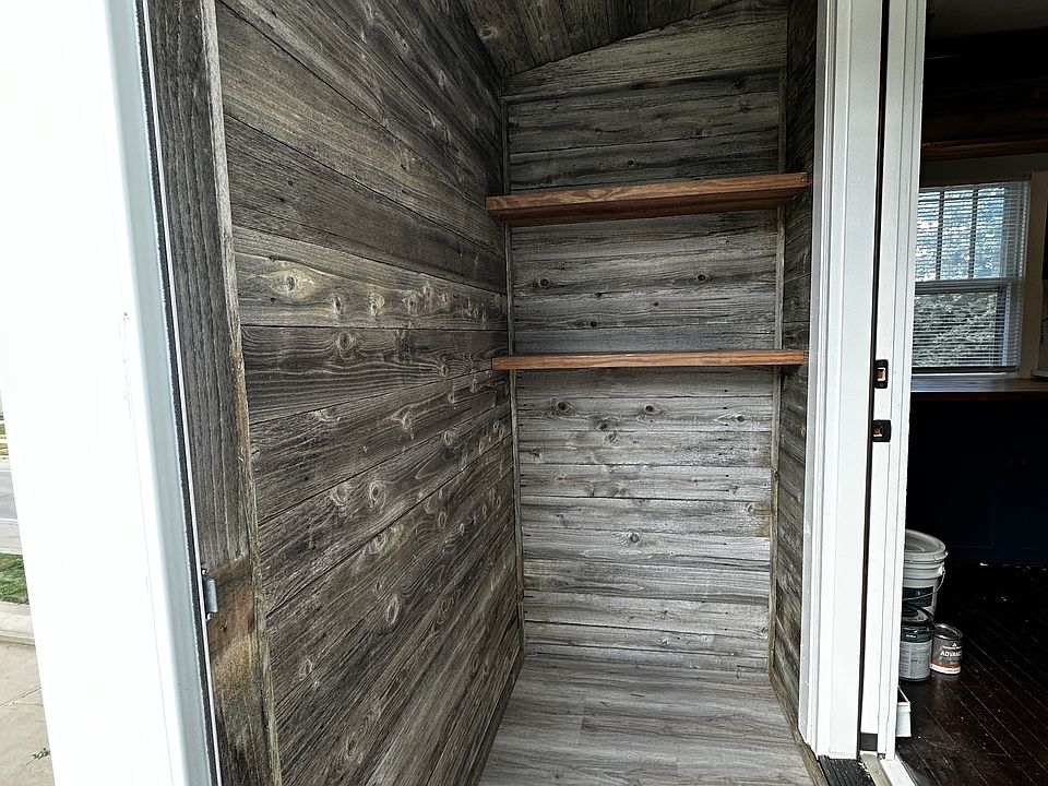Rear pantry way as you enter, with storage. Custom lined with recycled barn fence