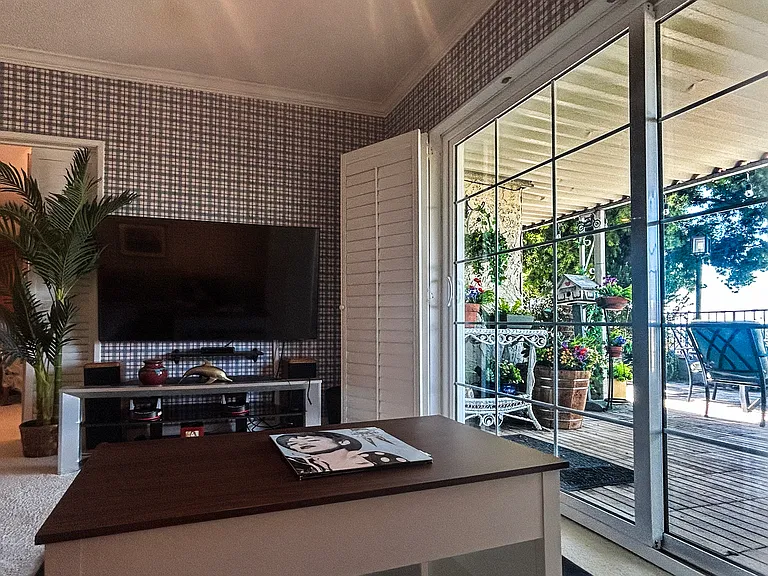 Big screen TV in entertainment room/office. open sliding french doors leading to an amazing deck overlooking the golf course, city and San Gabriel Mountains!